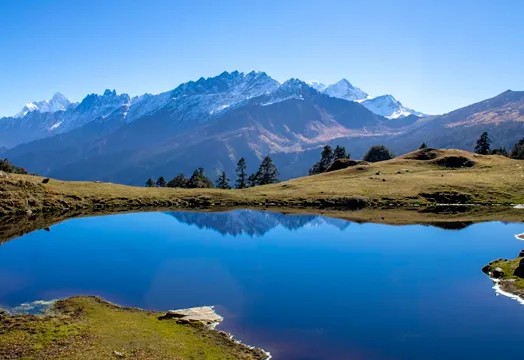 Group of trekkers sitting around a camping table inside a white tent